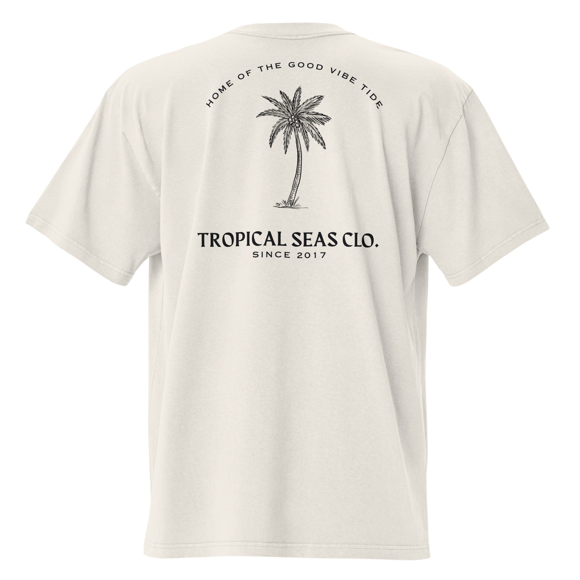 Boxy, oversized faded t-shirt in light beige with black palm tree and text graphic on back. Wide neck and dropped shoulders.