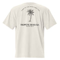 Light beige oversized t-shirt featuring a palm tree graphic and text on the back. Loose fit with dropped shoulders.