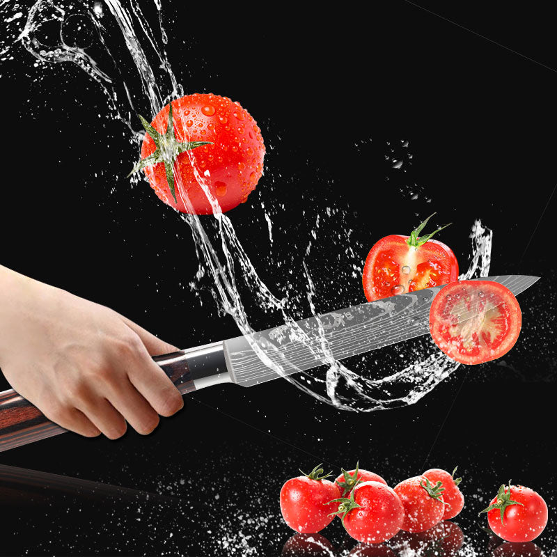Damascus Style Kitchen Knife with a polished blade, slicing through a tomato, with water splashing around.