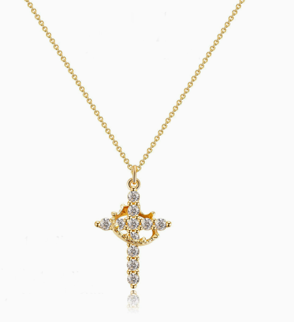 Delicate gold Y-shaped necklace featuring a crown and cross pendant adorned with sparkling stones.