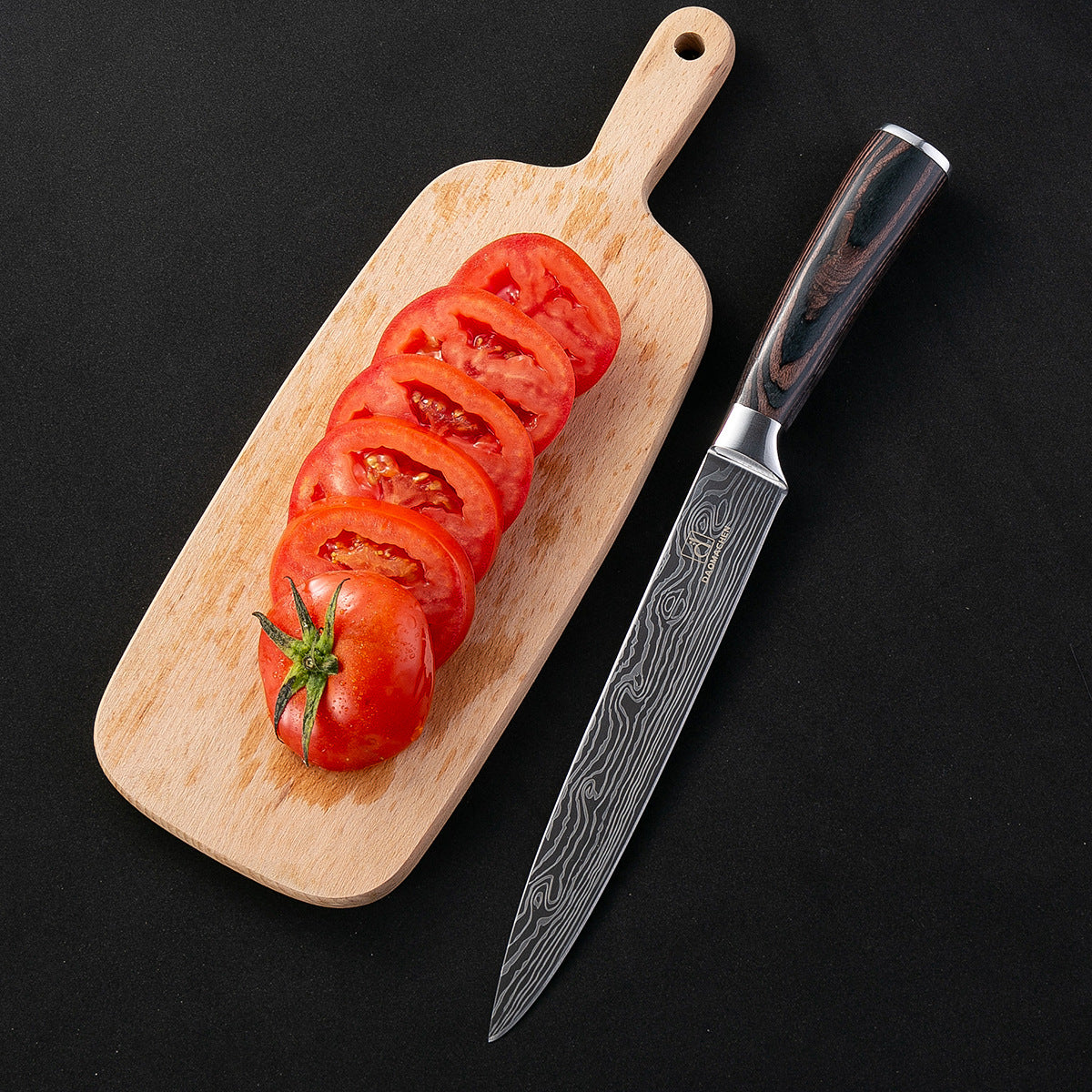 Damascus Style Kitchen Knife beside sliced tomatoes on a wooden cutting board against a black background.