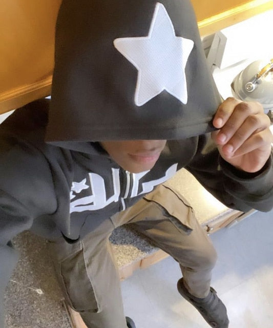 Star Printed Zip Up Hoodie in dark gray with a large white star on the hood, worn casually with relaxed-fit pants.