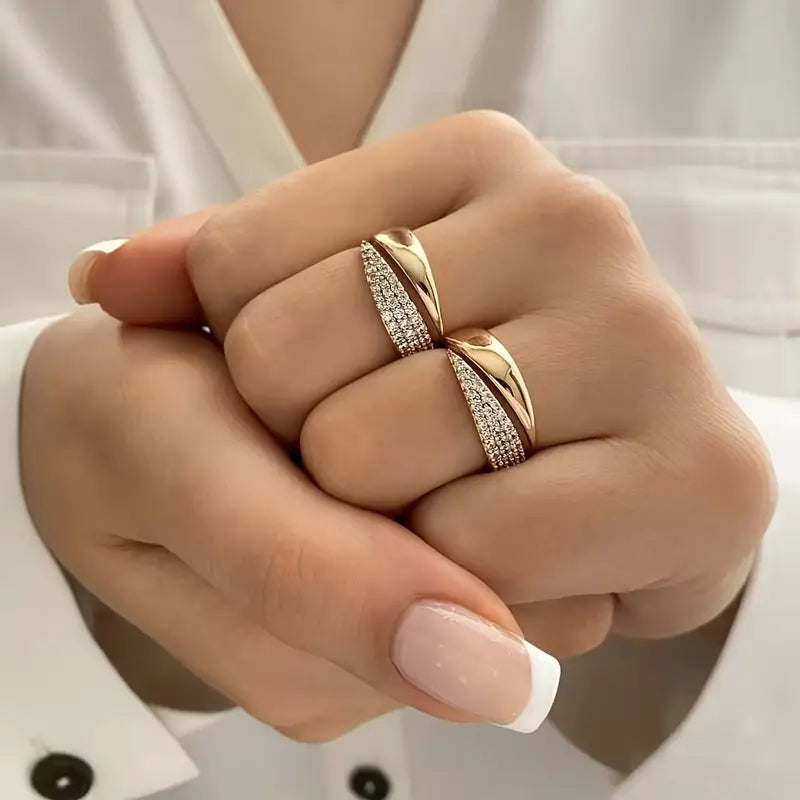 Elegant Adjustable Sparkle Ring in gold featuring multiple rows of sparkling stones, worn on two fingers with a neutral nail polish.