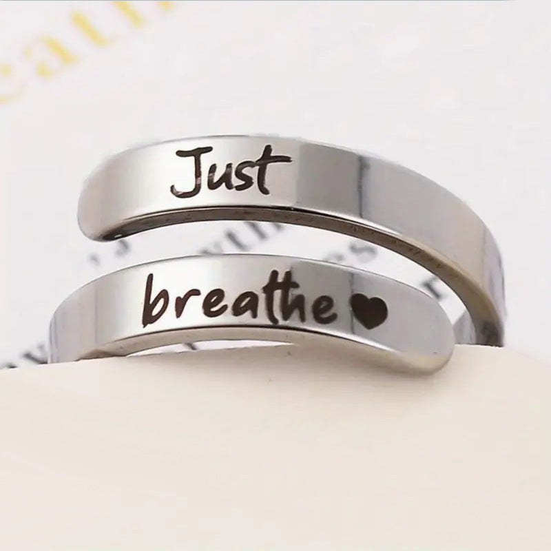 Silver spiral ring featuring “Just Breathe” engraving, heart-shaped design, made from tarnish-resistant stainless steel.