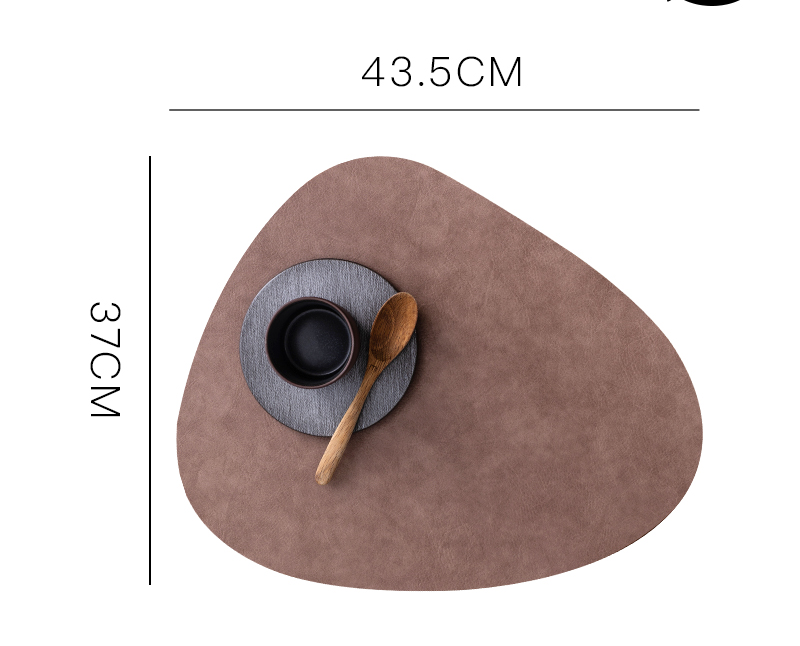 Waterproof leather placemat in a rich brown tone, featuring a stylish irregular shape, displayed with a bowl and spoon.