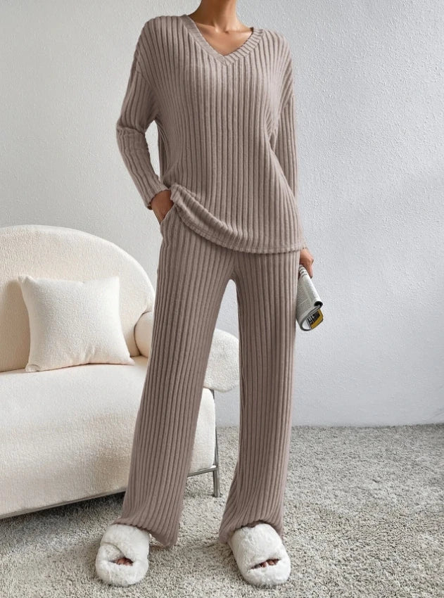 Casual 2-piece loungewear set in a soft taupe ribbed fabric, featuring a V-neck top and matching wide-leg pants.
