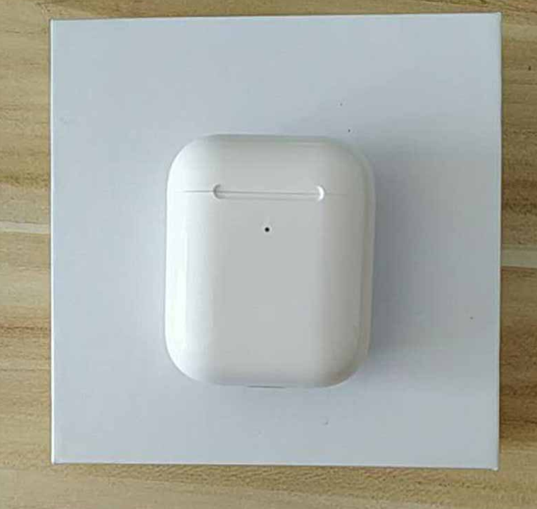 White wireless charging case for i80 TWS Bluetooth earbuds, placed on a light-colored surface.
