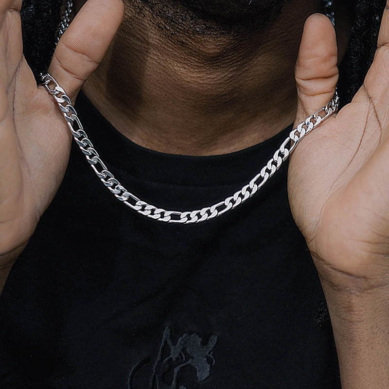 Twisted Rope Figaro Necklace displayed on model, featuring a shiny silver Cuban chain design with intricate links.