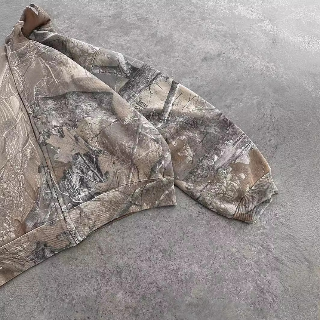 Unisex oversized hoodie in a brown camouflage print, featuring a relaxed fit and ribbed cuffs. Perfect for casual wear.