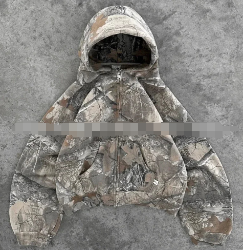 Unisex oversized hoodie in brown and gray camouflage print with a drawstring hood and zip closure.