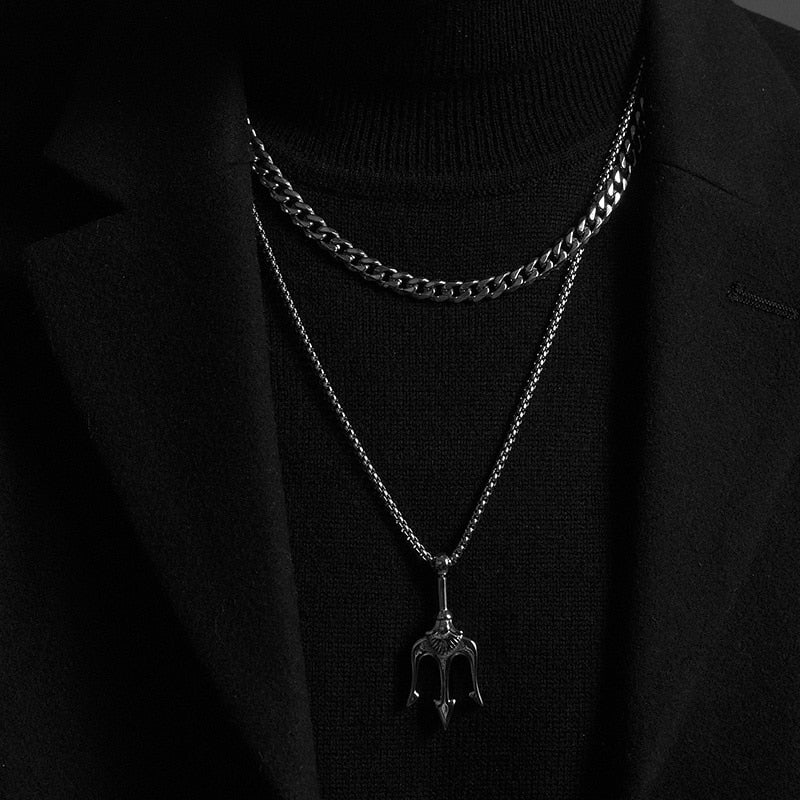 Twisted Rope Figaro Necklaces layered on a black turtleneck, featuring a mix of chain designs in silver tones.