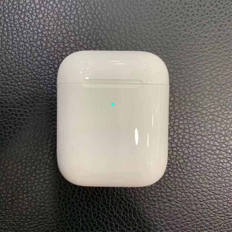 White wireless charging case for i80 TWS Bluetooth earbuds, featuring a small indicator light, set on a textured black surface.