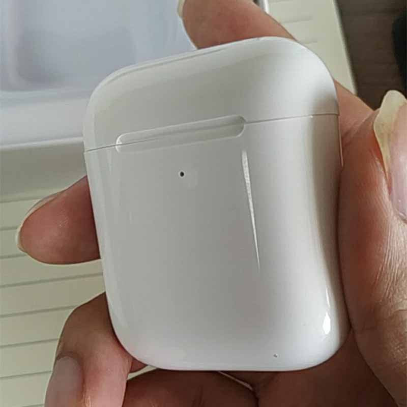 White i80 TWS Bluetooth earbuds case held in a hand, featuring a simple, sleek design with a single light indicator.