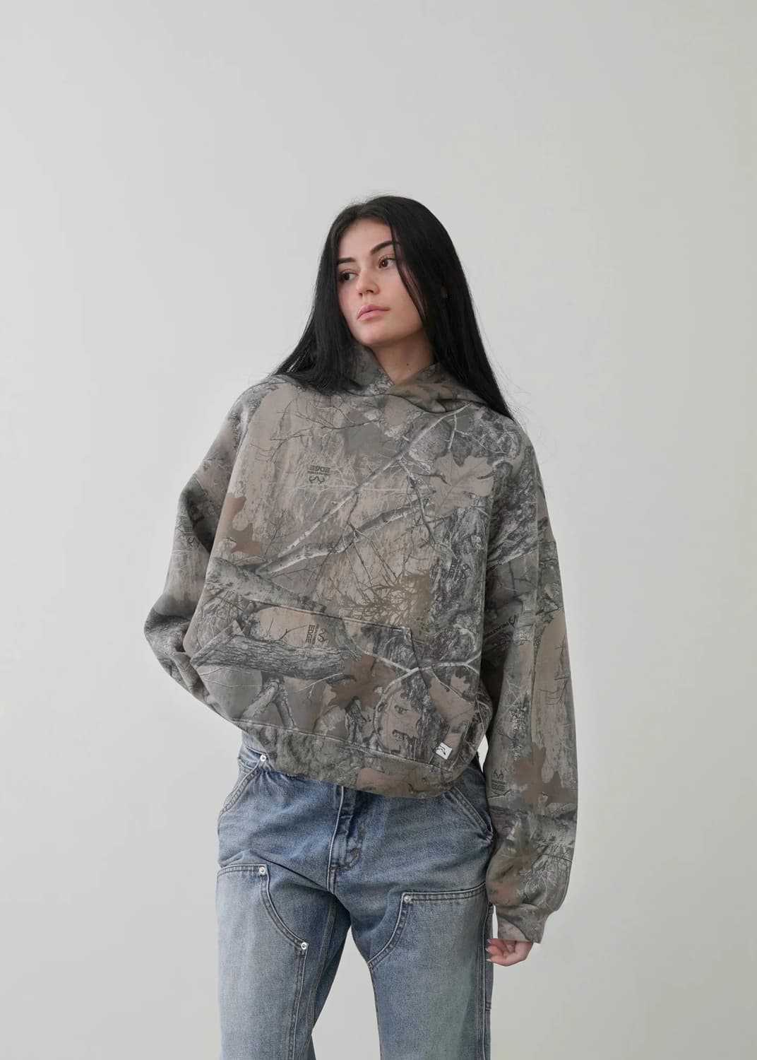 Urban Camo Retro Hoodie in a muted camouflage print, featuring a loose fit, adjustable hood, and a front pocket.