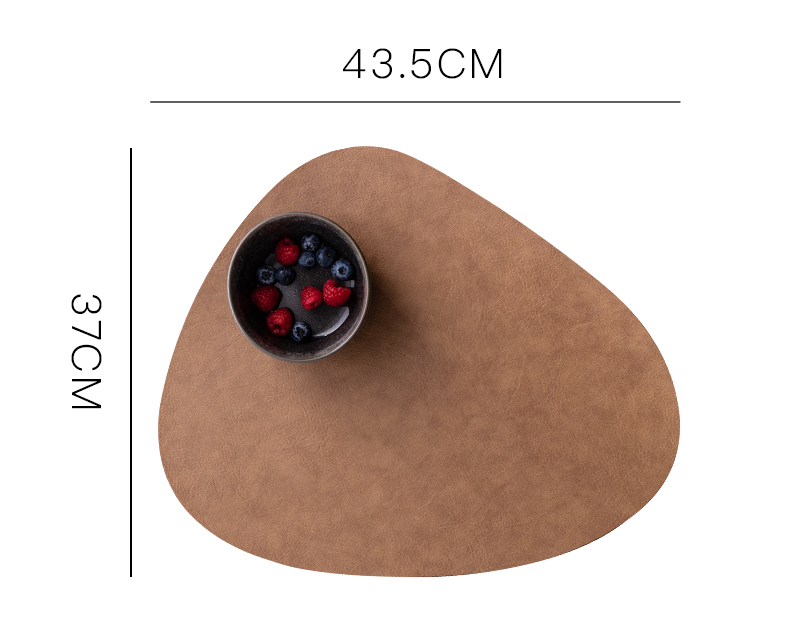 Waterproof brown leather placemat with a rounded shape, featuring a black bowl of mixed berries on top.