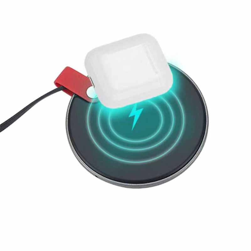Wireless charging pad with blue indicator light, a white charging case positioned on top, and a black base.