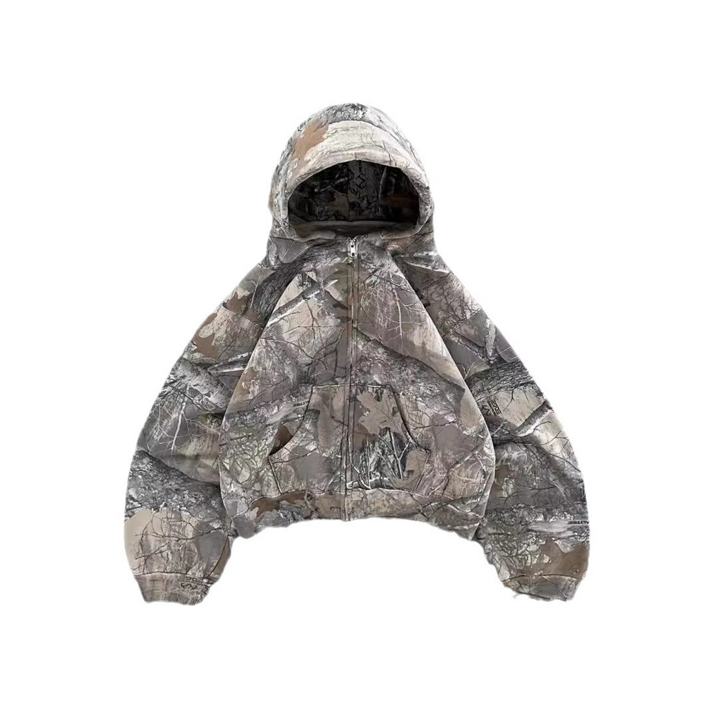 Unisex oversized hoodie in a camouflage print, featuring a zip closure and an adjustable hood for a relaxed fit.