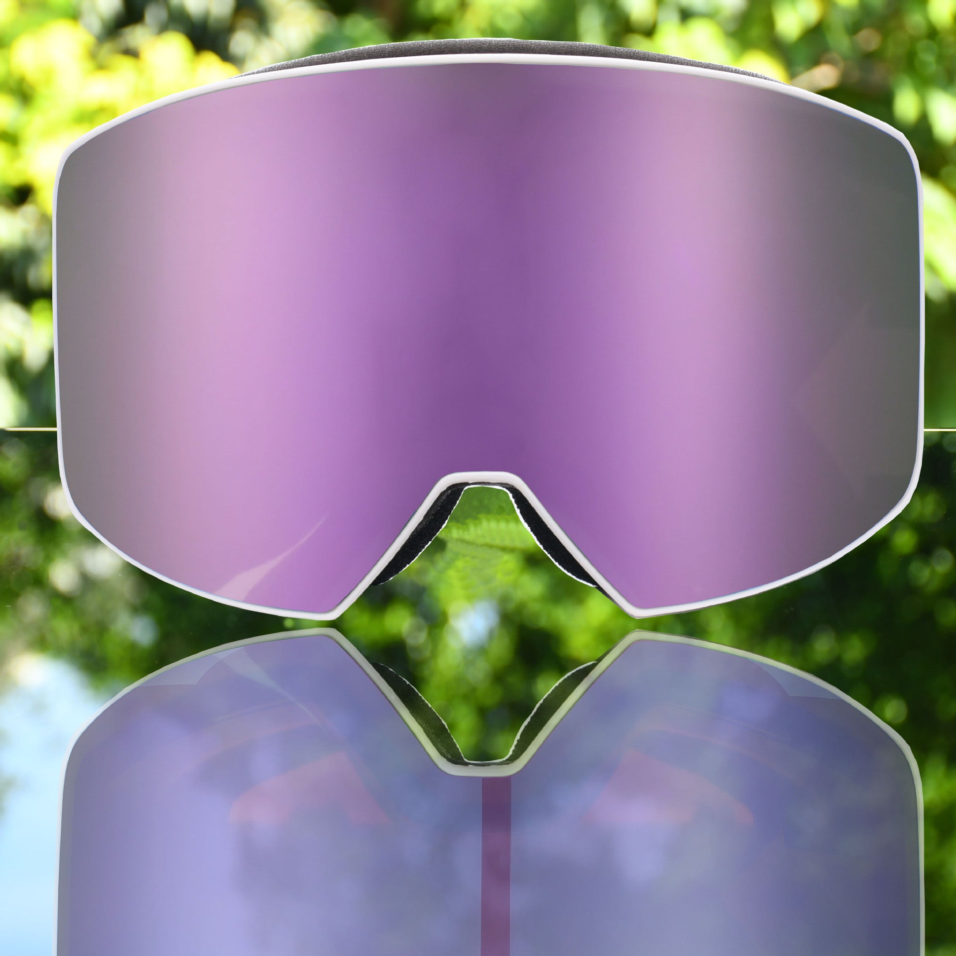 Purple ski goggles with a sleek design and reflective lens, featuring a white frame and black padding along the edges.
