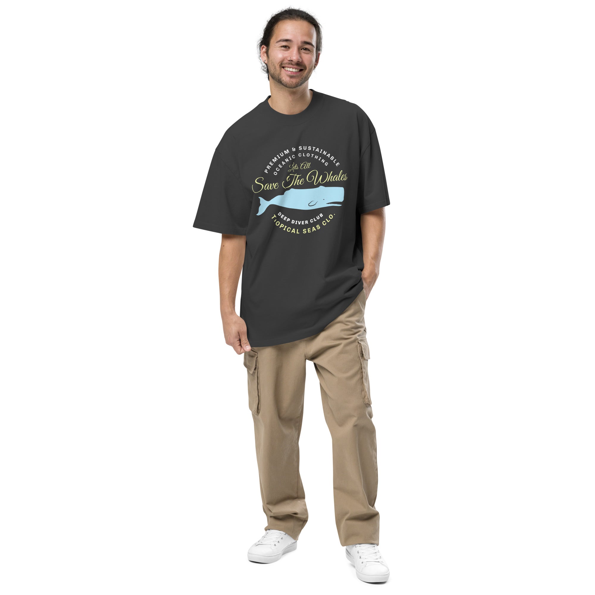 Oversized faded t-shirt in dark gray featuring "Save The Whales" graphic, worn with loose khaki pants and white sneakers.