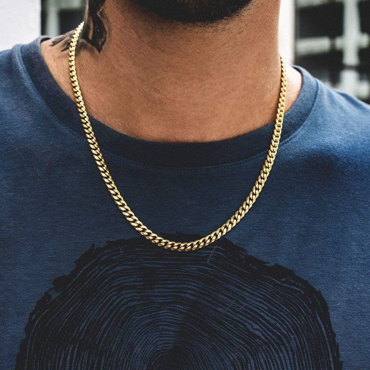 Twisted Rope Figaro Necklace in gold worn around the neck, paired with a dark blue t-shirt featuring a graphic print.