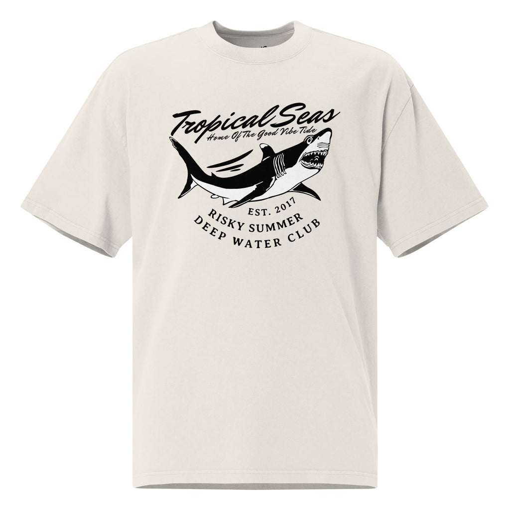 Oversized faded t-shirt in light beige with a black shark graphic and text, featuring a boxy fit and wide neck.