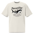 Oversized faded t-shirt in light beige with a black shark graphic and text, featuring a boxy fit and wide neck.