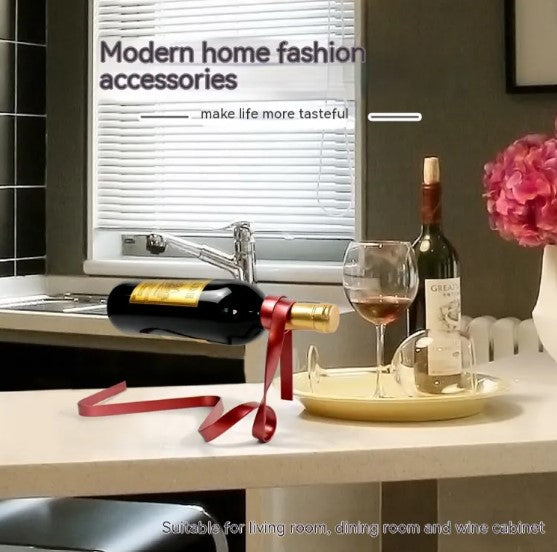 Creative floating iron wine rack in a ribbon design, holding a wine bottle with a glass on a countertop.