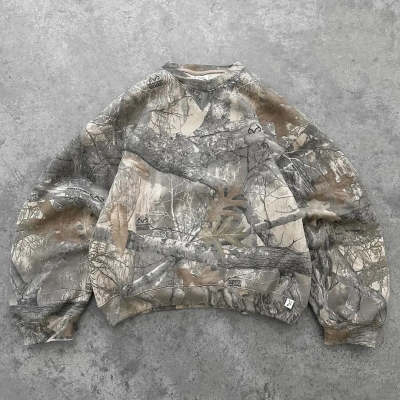 Oversized hoodie in a bold urban camouflage print, featuring a relaxed fit and ribbed cuffs. Ideal for casual wear.