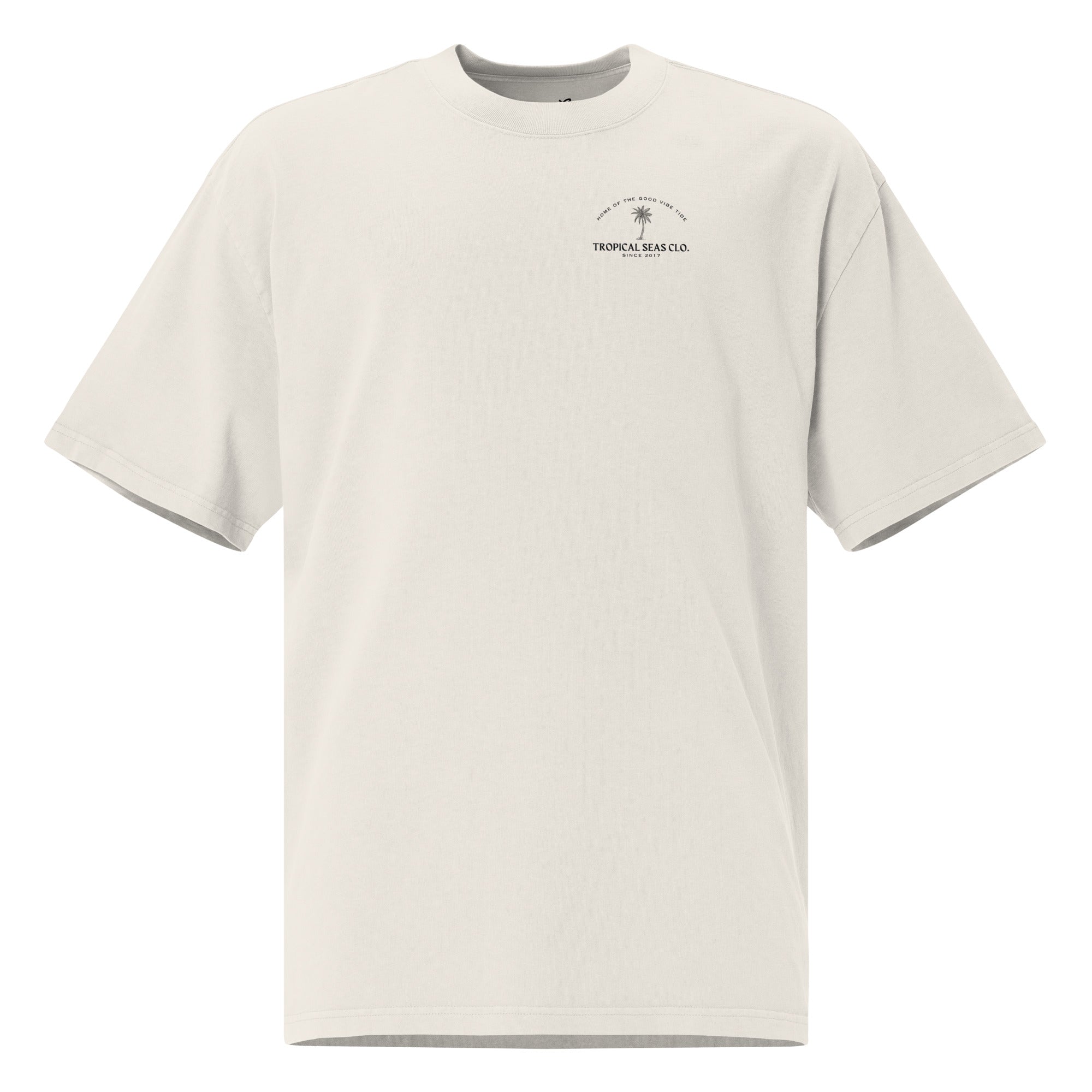 Faded oversized t-shirt in light beige with a wide neck, dropped shoulders, and small palm print detail.