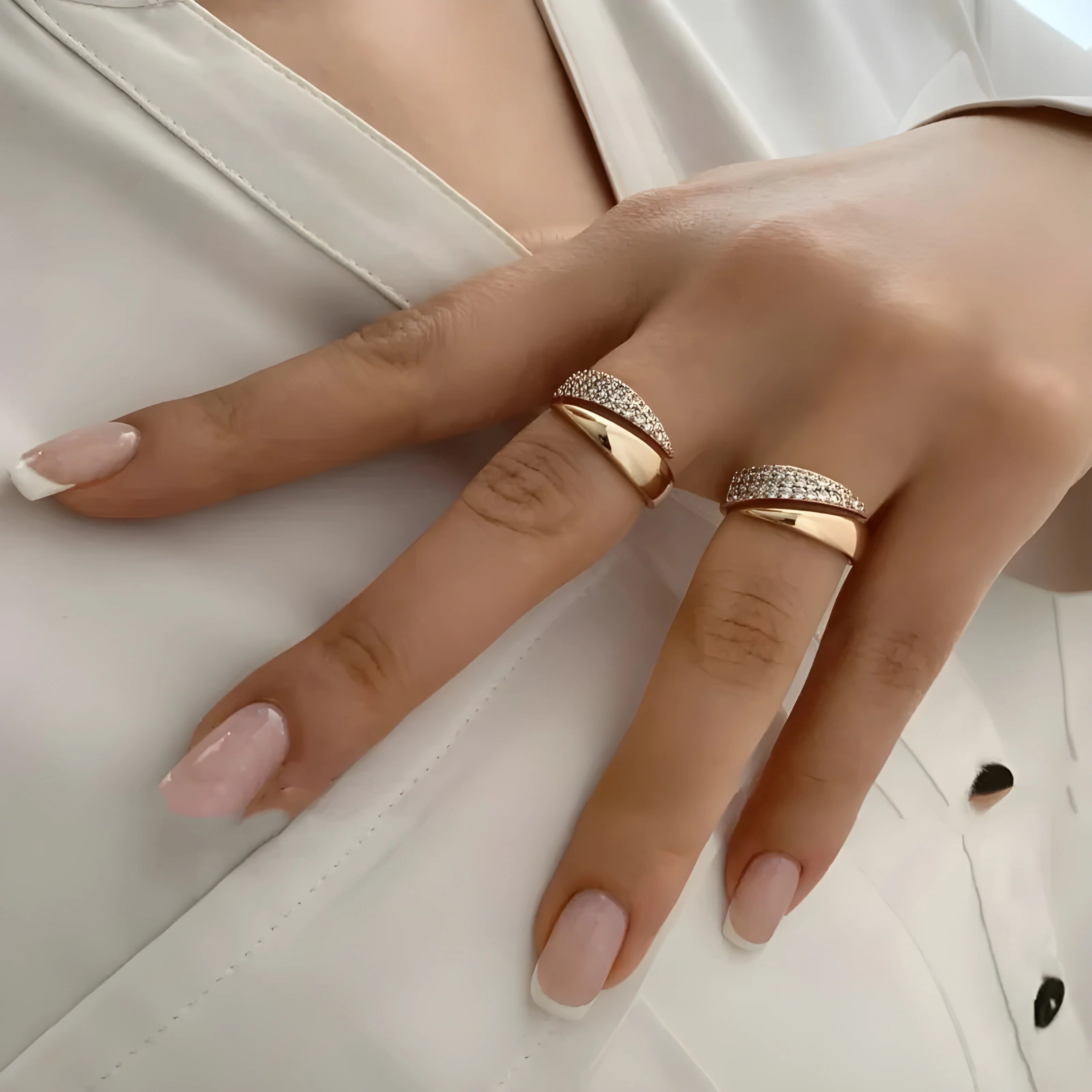 Elegant Adjustable Sparkle Ring shown on a hand with nude nail polish, featuring gold-tone rows of sparkling stones.